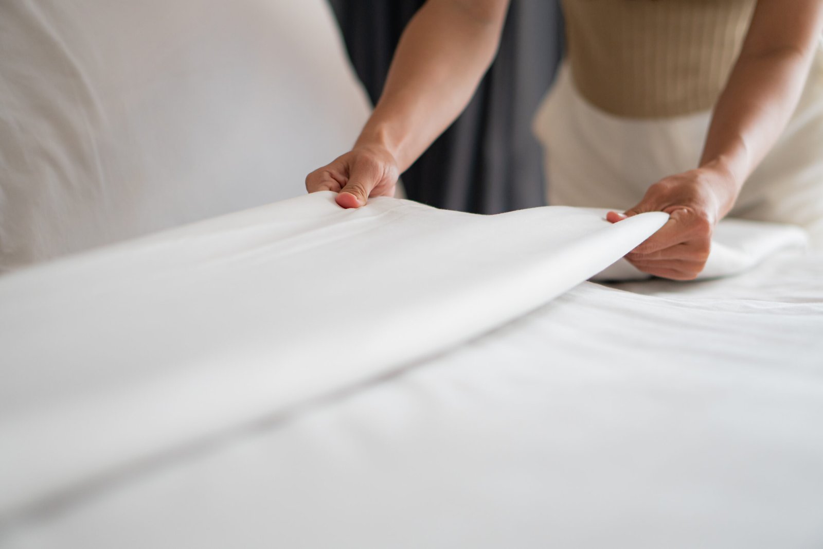 housewife-set-up-white-sheet-and-cleaning-in-room-2024-11-25-03-19-48-utc